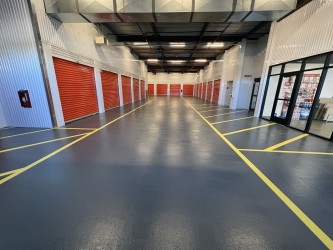 Endura-Plate topcoat on FRC rubber base coat to repair cracked cement parking substrate.