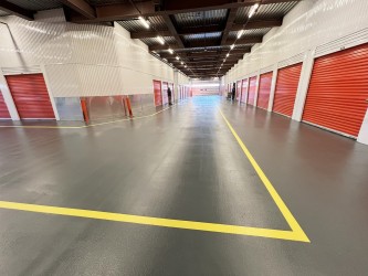 Endura-Plate topcoat on FRC flexible rubber base coat parking area.